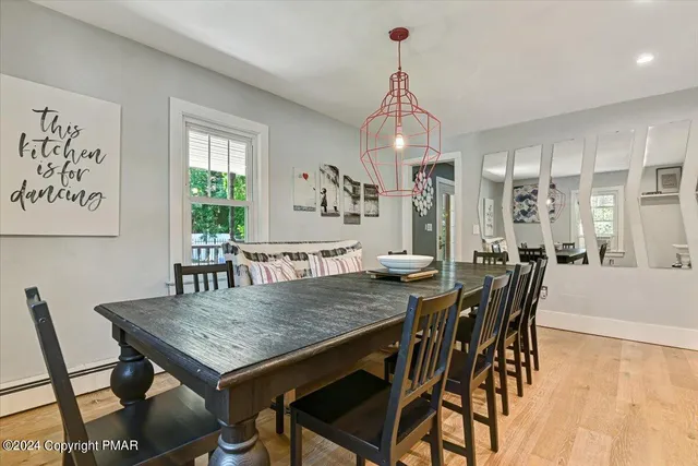 a view of an entryway with wooden floor and front door