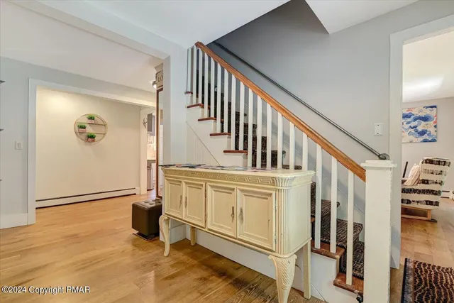 a living room with furniture a wooden floor and chandelier