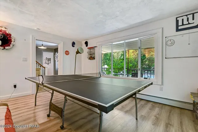 a living room with furniture a flat screen tv and kitchen view