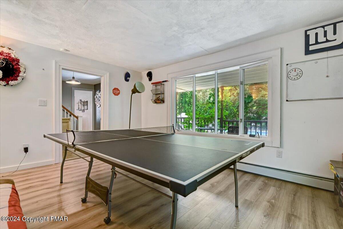 188 Olde Schoolhouse Road Cresco, PA 18326 - Photo 32 of 62 a living room with a table and a large window