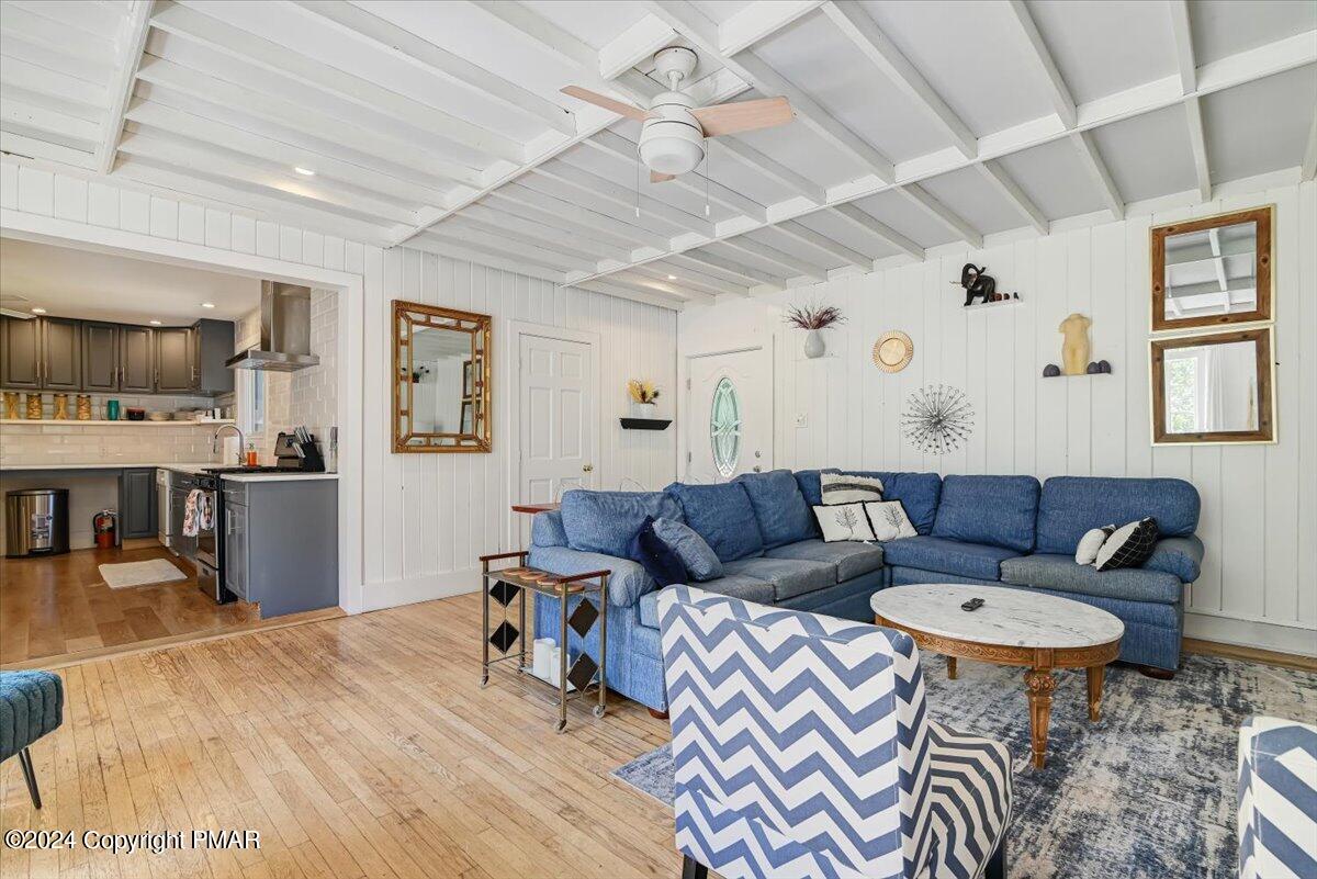 188 Olde Schoolhouse Road Cresco, PA 18326 - Photo 36 of 62 a living room with furniture a flat screen tv and kitchen view