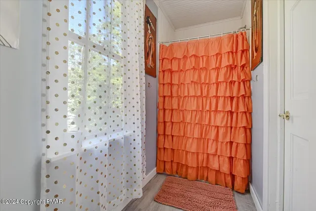 a view of a room with wooden floor and furniture