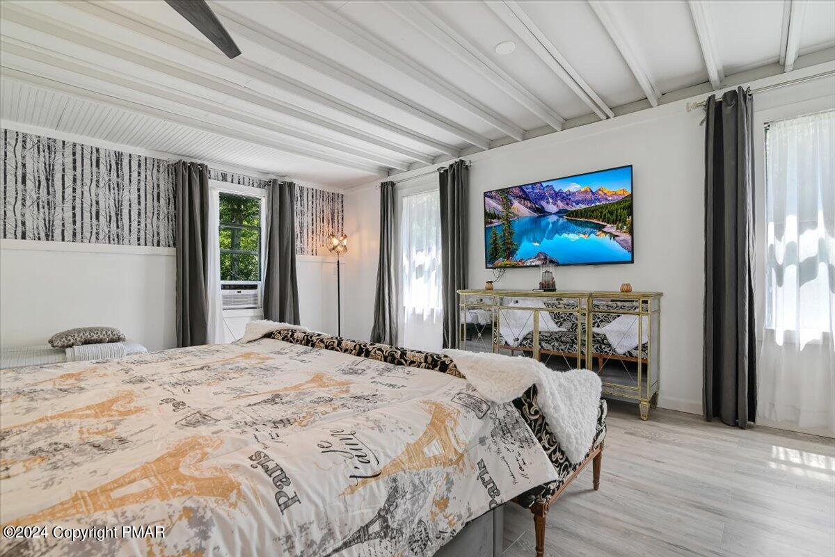 188 Olde Schoolhouse Road Cresco, PA 18326 - Photo 43 of 62 a bedroom with a bed and a flat screen tv