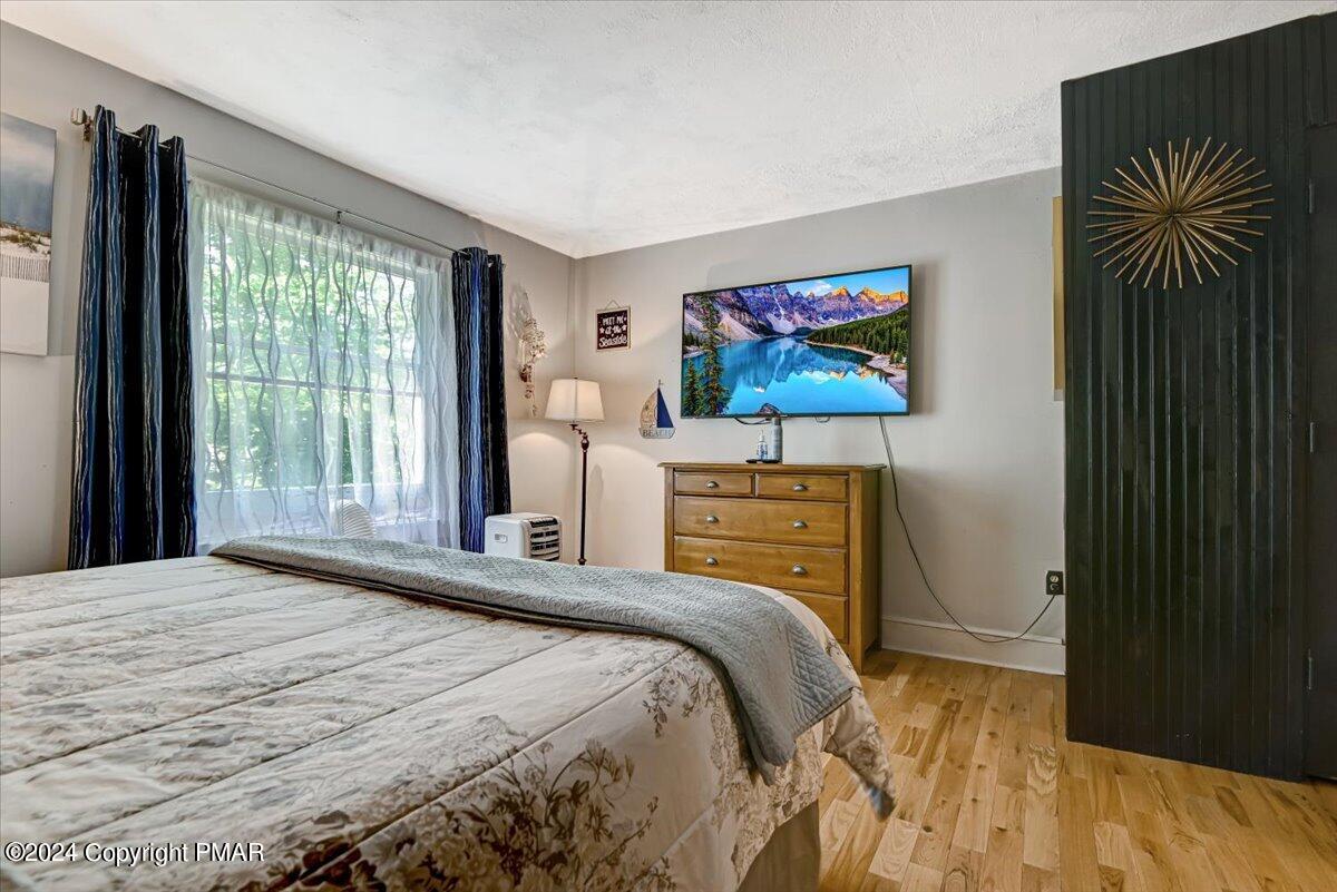 188 Olde Schoolhouse Road Cresco, PA 18326 - Photo 44 of 62 a bedroom with a bed and a flat screen tv