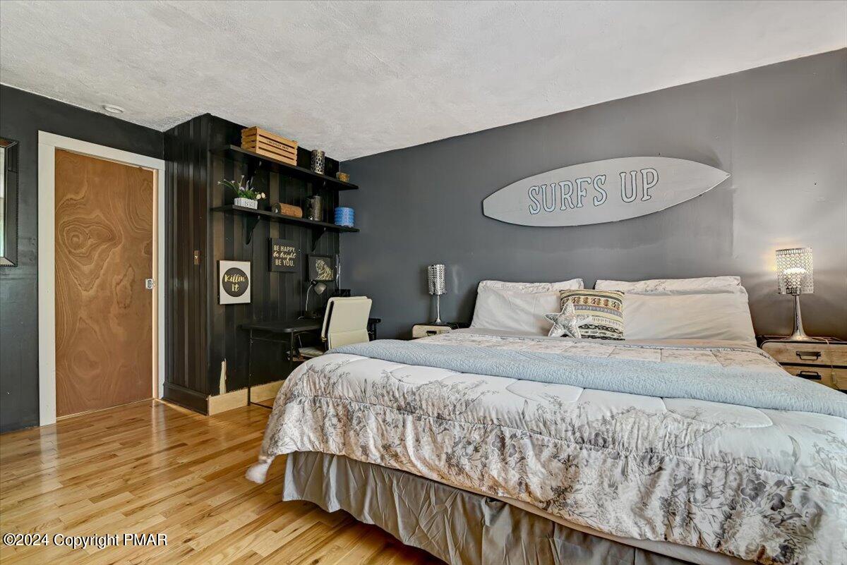 188 Olde Schoolhouse Road Cresco, PA 18326 - Photo 45 of 62 a bedroom with a bed and wooden floor