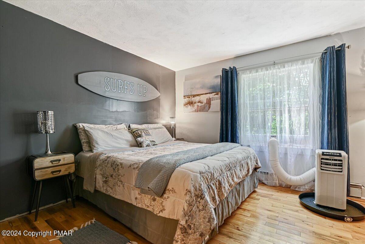 188 Olde Schoolhouse Road Cresco, PA 18326 - Photo 46 of 62 a bedroom with bed and wooden floor