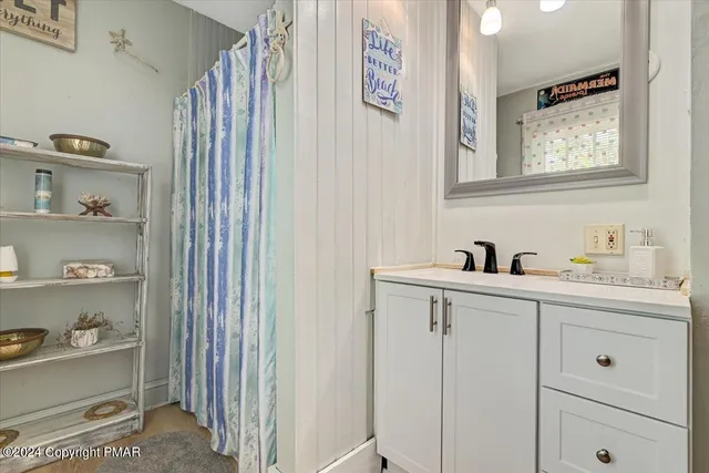 a view of a backyard with plants and large trees