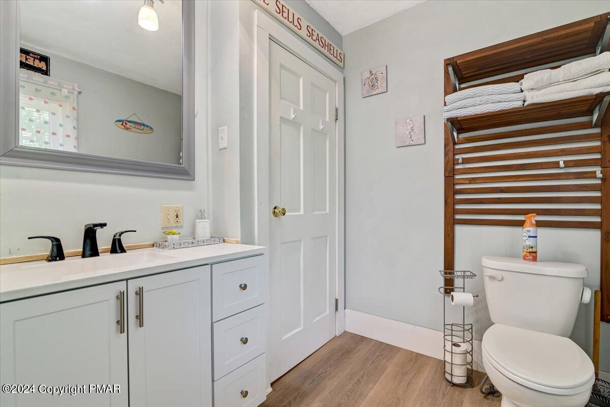 188 Olde Schoolhouse Road Cresco, PA 18326 - Photo 48 of 62 a bathroom with a toilet a sink and mirror