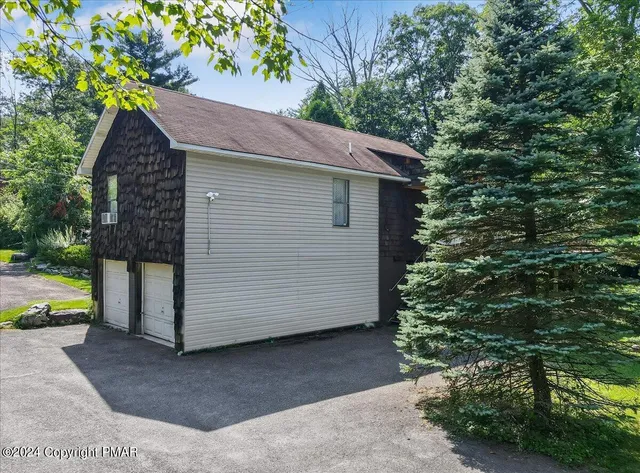 an aerial view of a house with garden space and street view