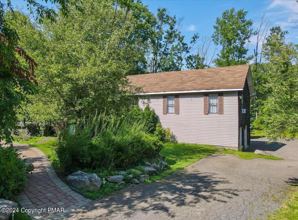 188 Olde Schoolhouse Road Cresco, PA 18326 - Photo 56 of 62 a view of a backyard with plants and large trees