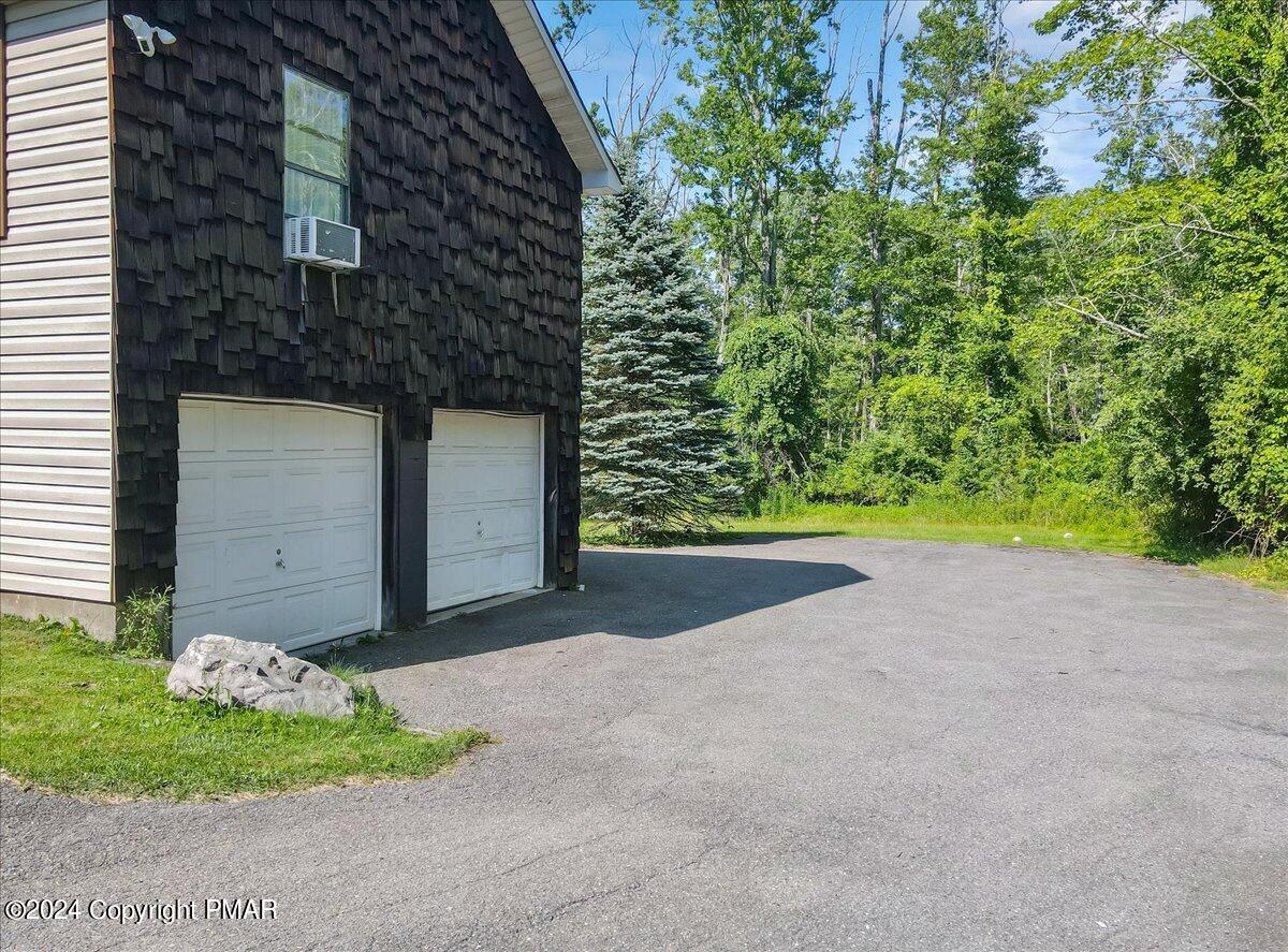 188 Olde Schoolhouse Road Cresco, PA 18326 - Photo 6 of 62 a front view of a house with a yard and garage