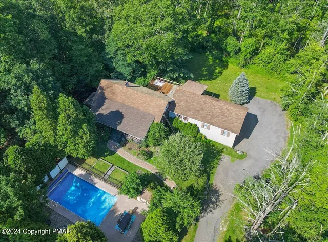 an aerial view of a house having yard patio and backyard