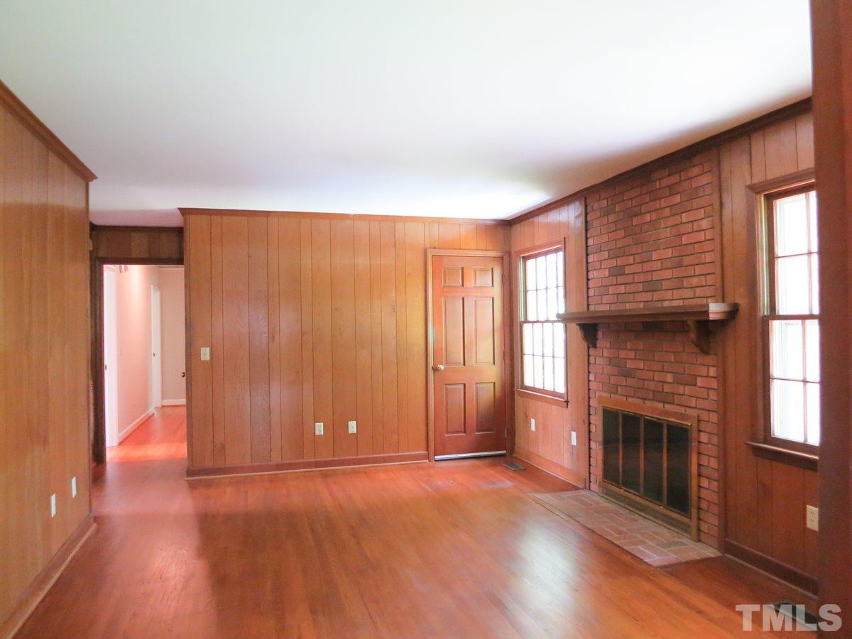 813 Autumn Court Raleigh, NC 27609 - Photo 11 of 25 The lg Family Rm features a brick FP & door to the Patio & backyard.