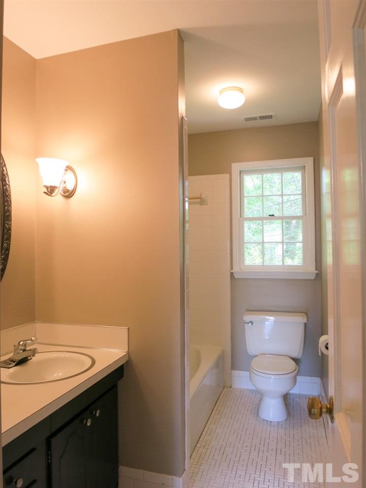 813 Autumn Court Raleigh, NC 27609 - Photo 19 of 25 The Hall Bath has a tile floor, tiled tub/shower, NEW lighting & linen closet (plus lg linen closet in hallway).