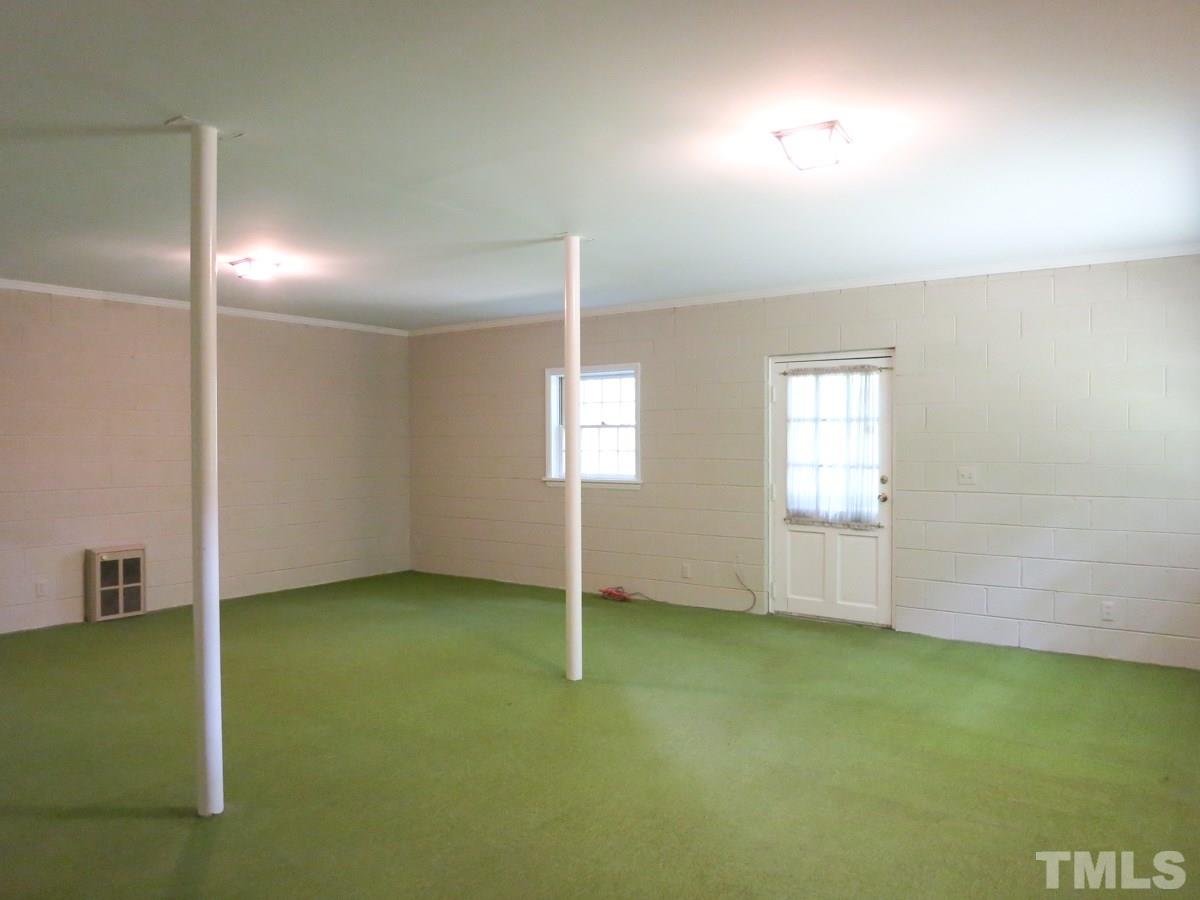 813 Autumn Court Raleigh, NC 27609 - Photo 22 of 25 The Rec Rm features a door to the side of the home.