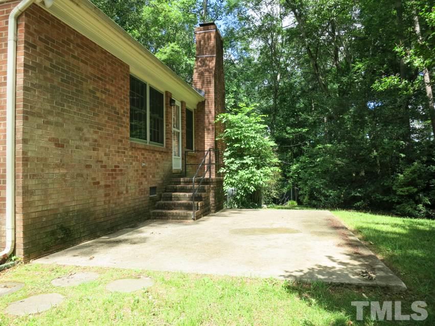 813 Autumn Court Raleigh, NC 27609 - Photo 23 of 25 View of the lg Patio off the Family Rm in the private backyard surrounded by trees.