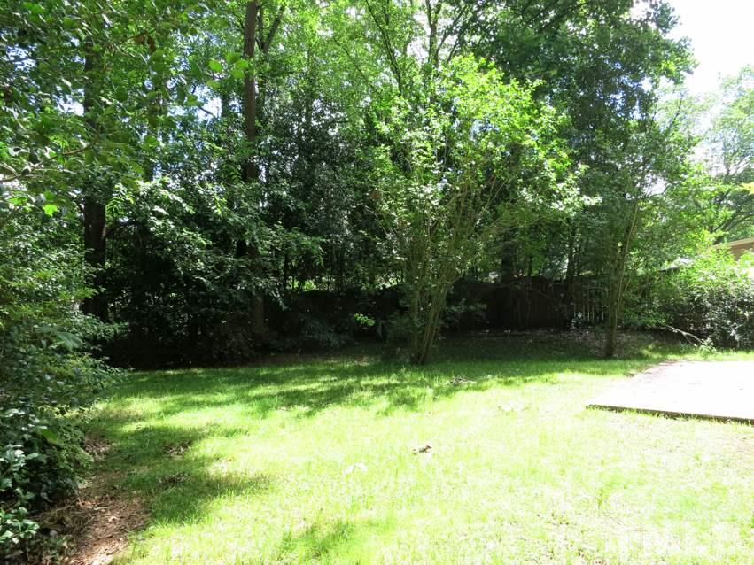 813 Autumn Court Raleigh, NC 27609 - Photo 24 of 25 The private backyard is surrounded by trees.