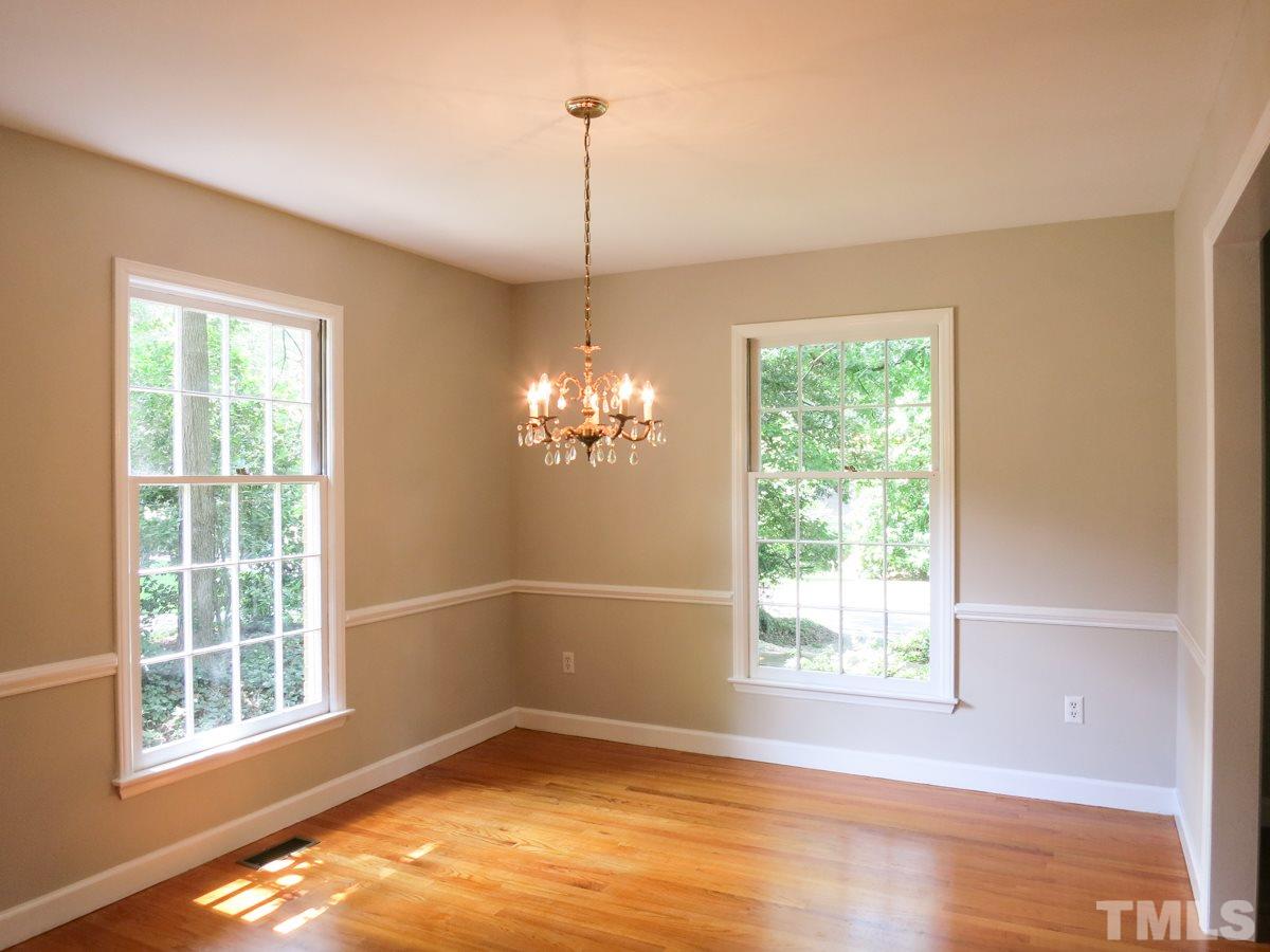 813 Autumn Court Raleigh, NC 27609 - Photo 6 of 25 The sunny formal Dining Rm offers chair rail molding & swinging door to the eat-in Kitchen.