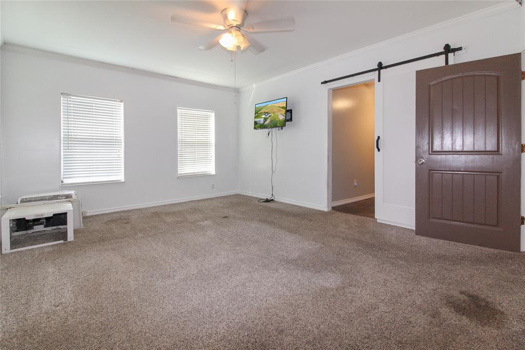 455 Hughes Cemetery Road Italy, TX 76651 - Photo 31 of 40 a view of empty room with windows and ceiling fan