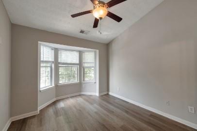 5450 Hampton Court Atlanta, GA 30349 - Photo 11 of 15 an empty room with chandelier fan and windows