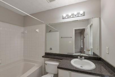 5450 Hampton Court Atlanta, GA 30349 - Photo 12 of 15 a bathroom with a sink double vanity granite tub and a mirror