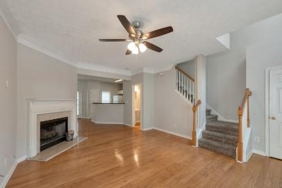 5450 Hampton Court Atlanta, GA 30349 - Photo 3 of 15 a view of an empty room with wooden floor a ceiling fan and a fireplace