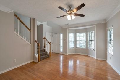 5450 Hampton Court Atlanta, GA 30349 - Photo 5 of 15 a view of an empty room with wooden floor and a window