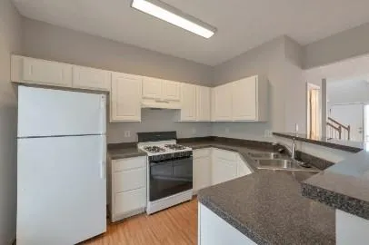 a kitchen with a stove a refrigerator and a sink