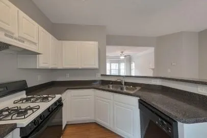 a kitchen with a sink stove and cabinets