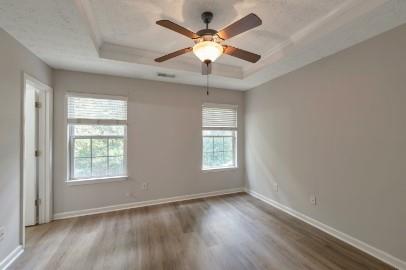 5450 Hampton Court Atlanta, GA 30349 - Photo 10 of 15 a view of an empty room with wooden floor and a window