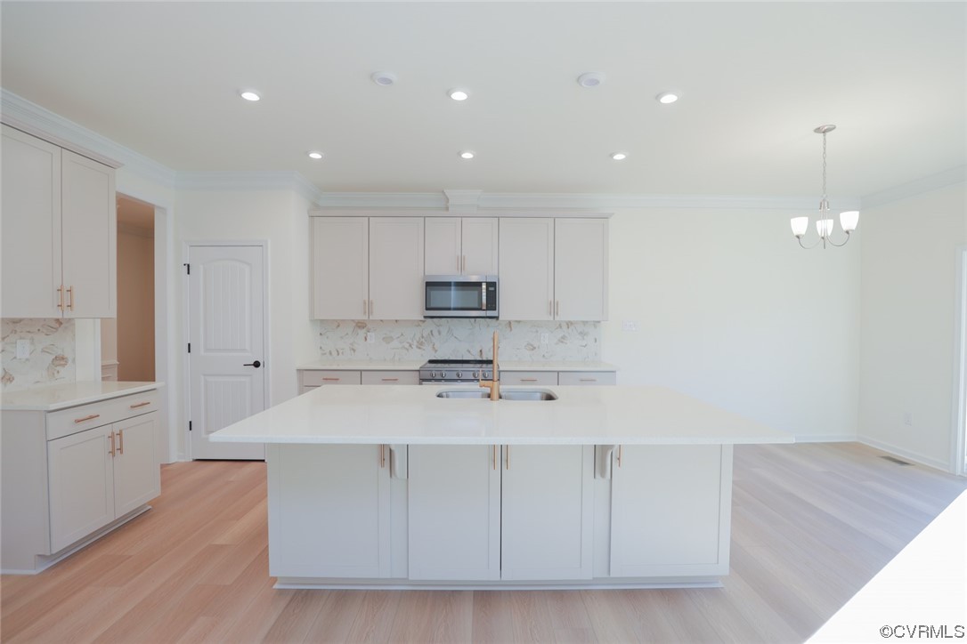 3843 Belspring Road Chester, VA 23831 - Photo 9 of 36 a large kitchen with kitchen island a sink stainless steel appliances and cabinets