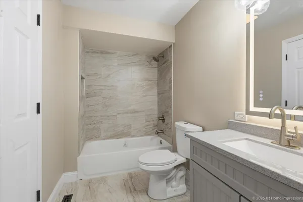 a bathroom with a sink a toilet and a bathtub