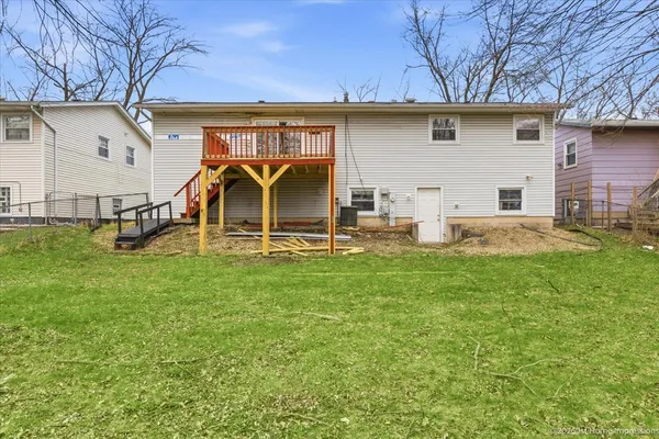 a view of a house with backyard sitting area and garden
