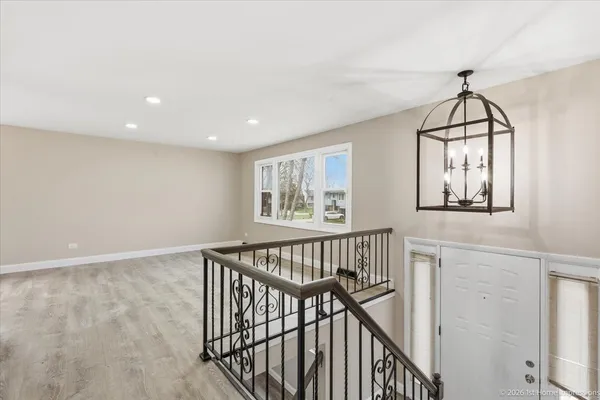 a view of entryway with wooden floor and windows