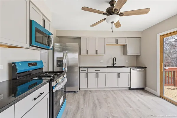 a kitchen with stainless steel appliances a stove a sink and a refrigerator