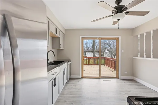a kitchen with a sink a counter top space cabinets and stainless steel appliances