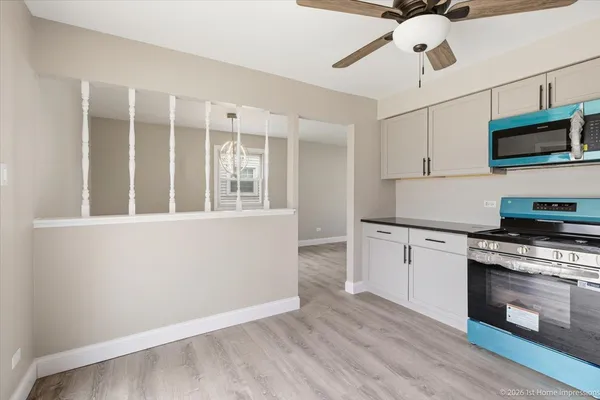 a kitchen with stainless steel appliances granite countertop a stove and a microwave