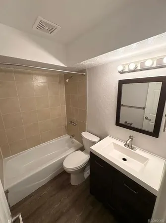a bathroom with a sink toilet a mirror and shower