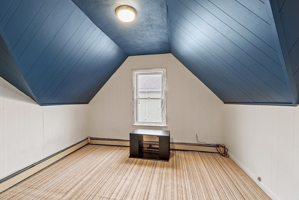 36 Florence Street Everett, MA 02149 - Photo 13 of 26 a view of a hallway with wooden floor and a window