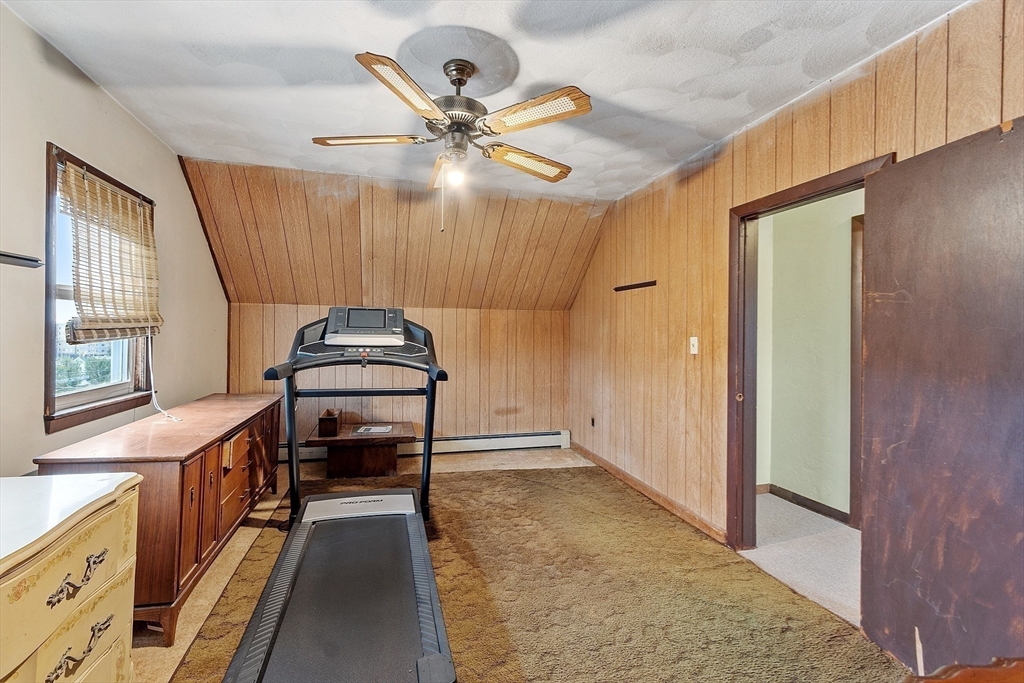 36 Florence Street Everett, MA 02149 - Photo 19 of 26 a view of a livingroom with furniture window wooden floor and a ceiling fan