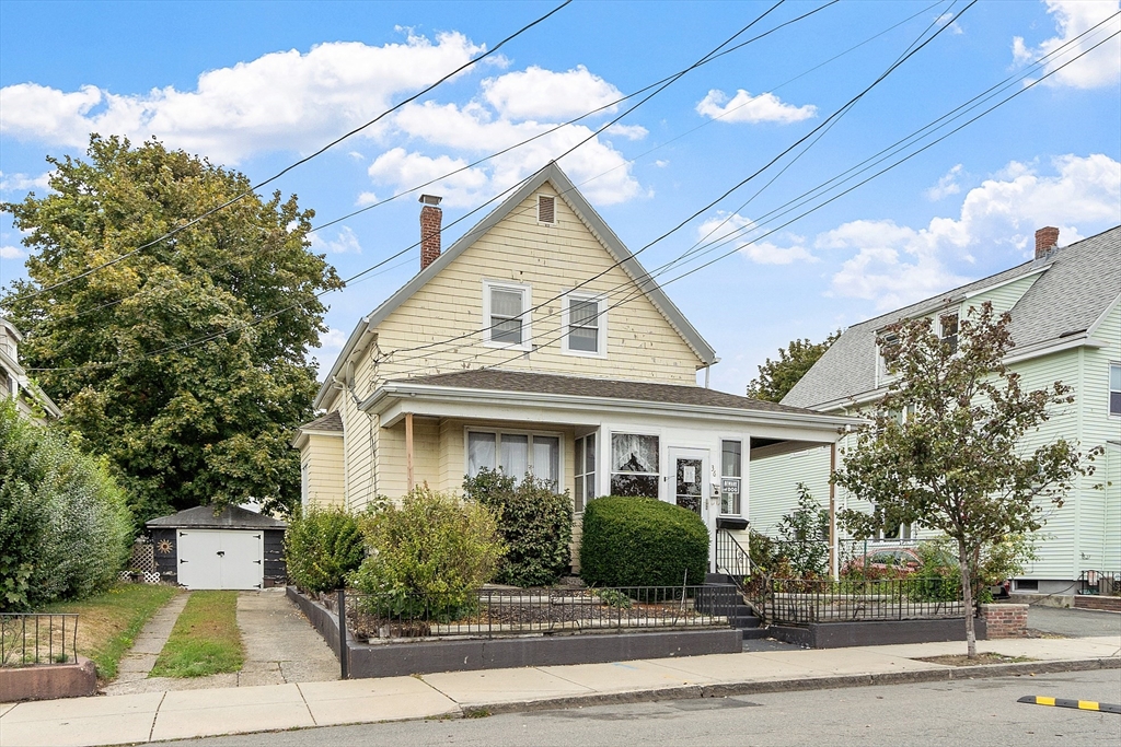 36 Florence Street Everett, MA 02149 - Photo 2 of 26 a front view of a house with a yard