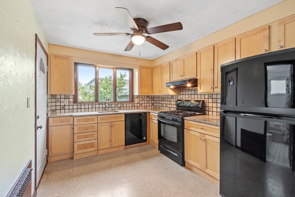 36 Florence Street Everett, MA 02149 - Photo 3 of 26 a kitchen with stainless steel appliances granite countertop a stove sink and refrigerator
