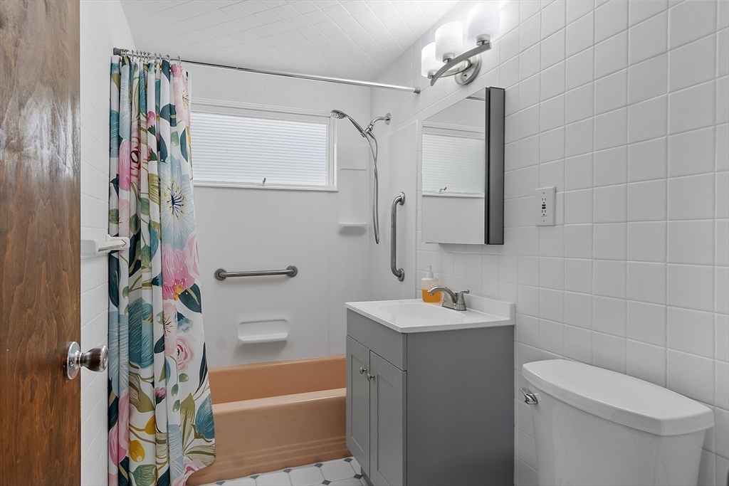 36 Florence Street Everett, MA 02149 - Photo 6 of 26 a bathroom with a sink toilet and shower