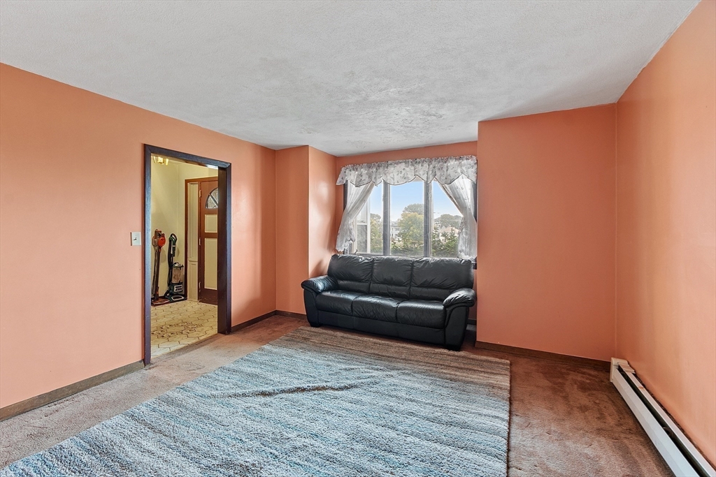36 Florence Street Everett, MA 02149 - Photo 9 of 26 a living room with furniture and a window