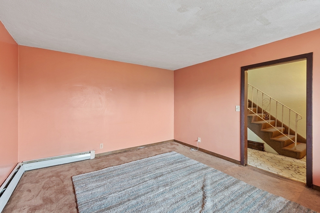 36 Florence Street Everett, MA 02149 - Photo 10 of 26 an empty room with wooden floor and windows
