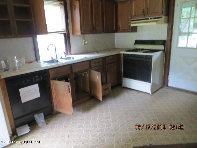 126 Monomonock Road Cresco, PA 18326 - Photo 4 of 9 a kitchen with a sink cabinets and a window