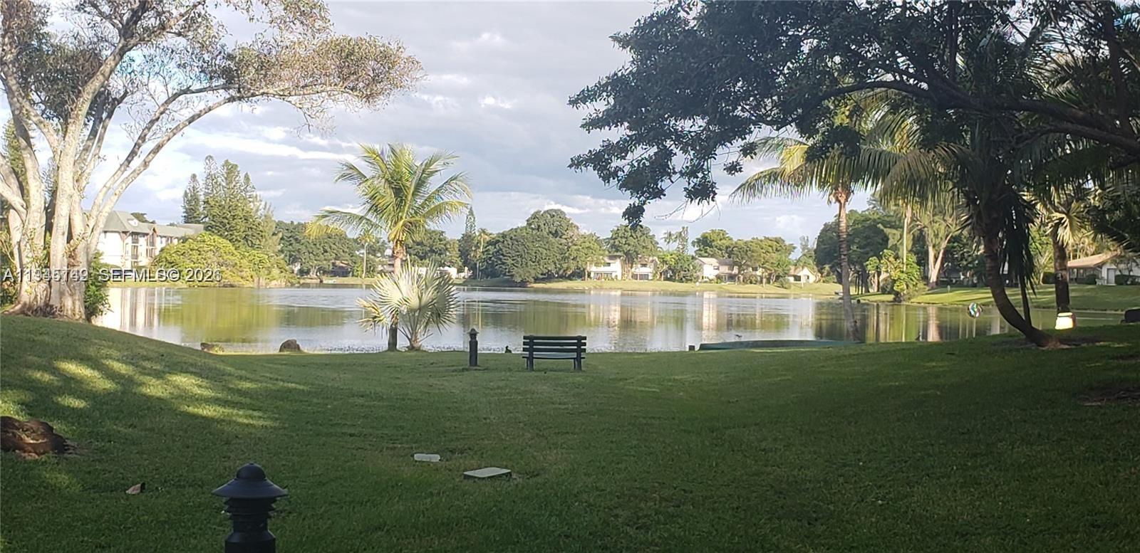 3426 Spring Bluff Place, Unit 36 Lauderhill, FL 33319 - Photo 14 of 14 a view of a lake with a big yard and large trees