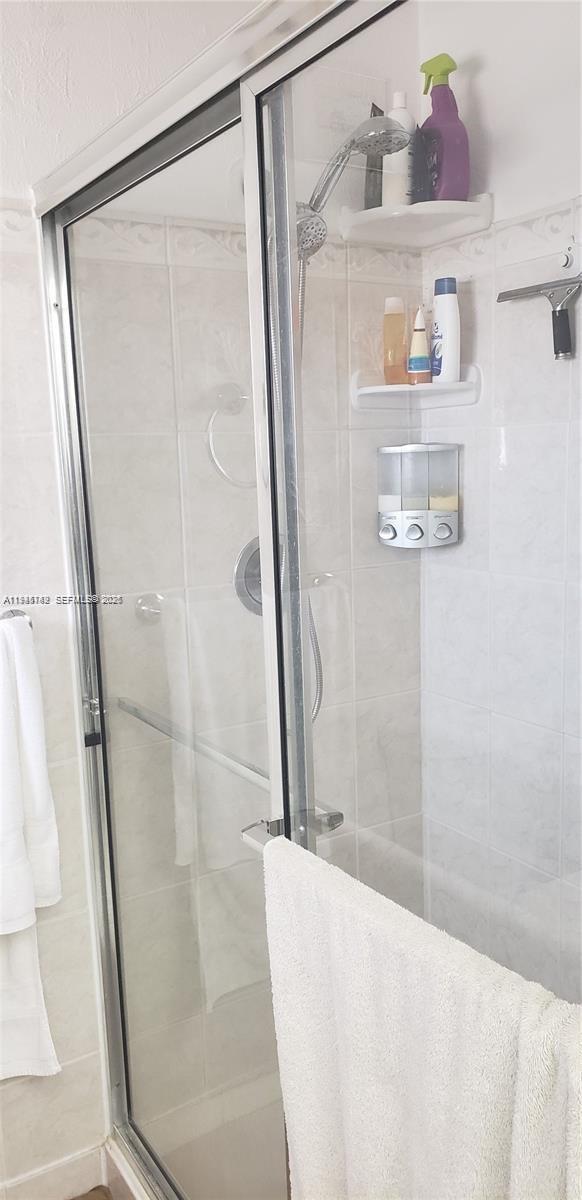 3426 Spring Bluff Place, Unit 36 Lauderhill, FL 33319 - Photo 7 of 14 a bathroom with a bathtub and a shower