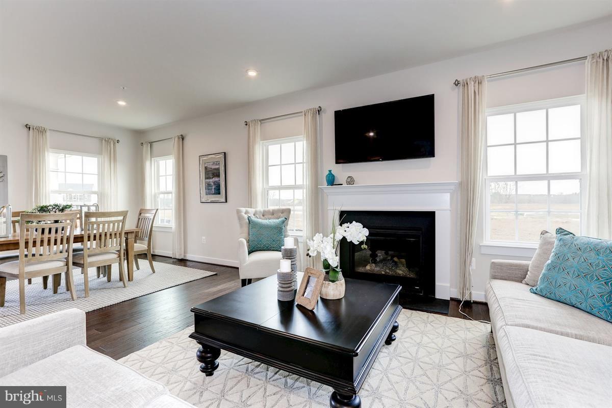 1244 Upper Patuxent Ridge Road Odenton, MD 21113 - Photo 5 of 23 a living room with furniture fireplace and flat screen tv