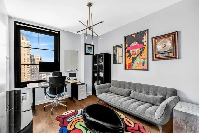 a bathroom with a granite countertop sink a toilet a mirror and shower